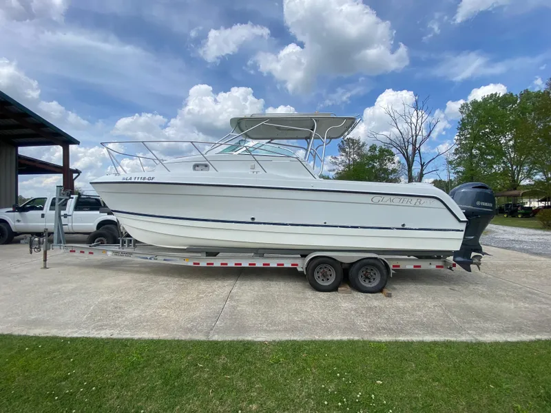 Slide: The Image of 2001 Glacier Bay 2670 Island Runner boat on trailer under cloudy sky. - 9