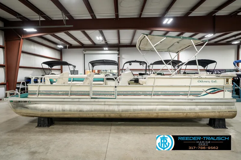 Slide: The Image of 1998 Odyssey 25 pontoon boat in indoor storage facility. - 11