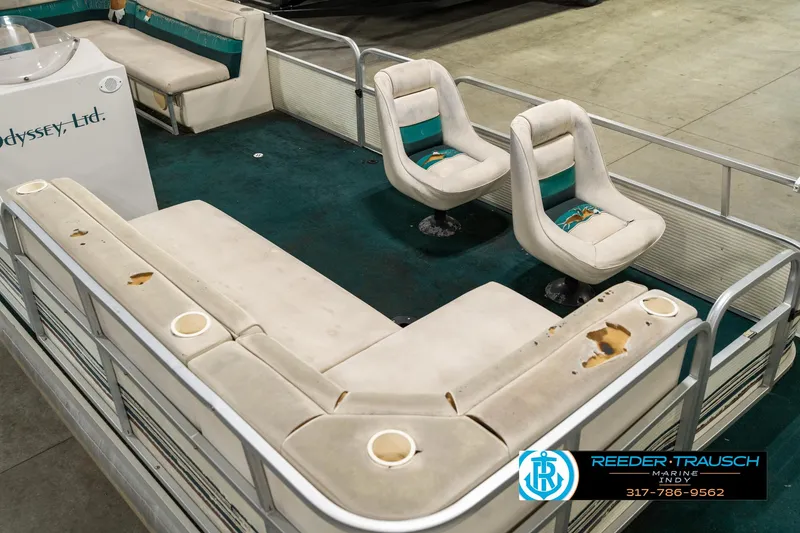 Slide: The Image of 1998 Odyssey 25 boat interior with worn seating and green carpet. - 13