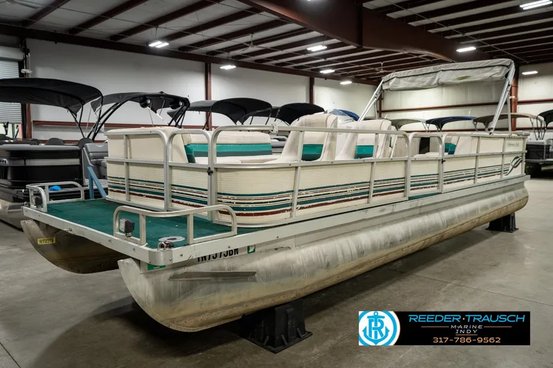 Slide: The Image of 1998 Odyssey 25 pontoon boat in indoor showroom, side view. - 2
