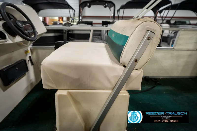 Slide: The Image of 1998 Odyssey 25 boat interior with beige seating and steering wheel. - 25