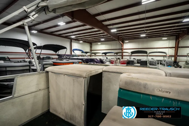 Slide: The Image of Indoor storage of 1998 Odyssey 25 boats with covered seating and metal roof. - 27