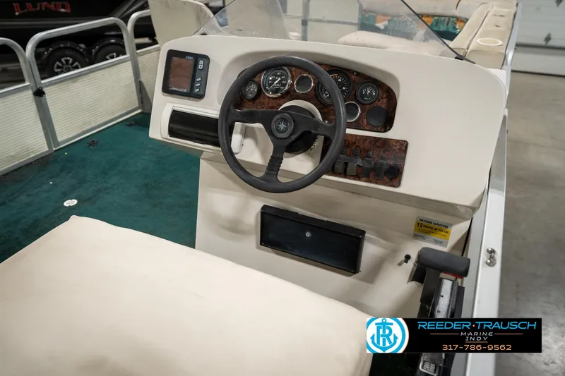 Slide: The Image of Steering console of a 1998 Odyssey 25 boat with gauges and controls. - 29