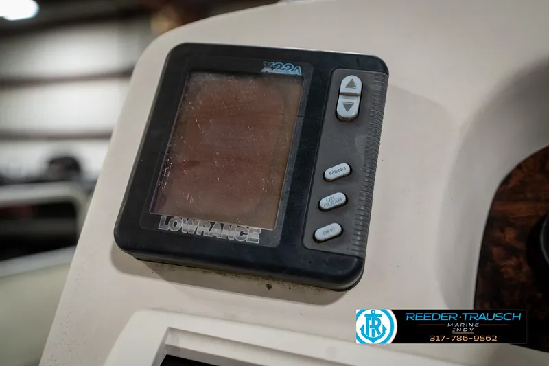 Slide: The Image of Lowrance fish finder on 1998 Odyssey 25 boat dashboard, Reeder-Trausch Marine logo visible. - 32