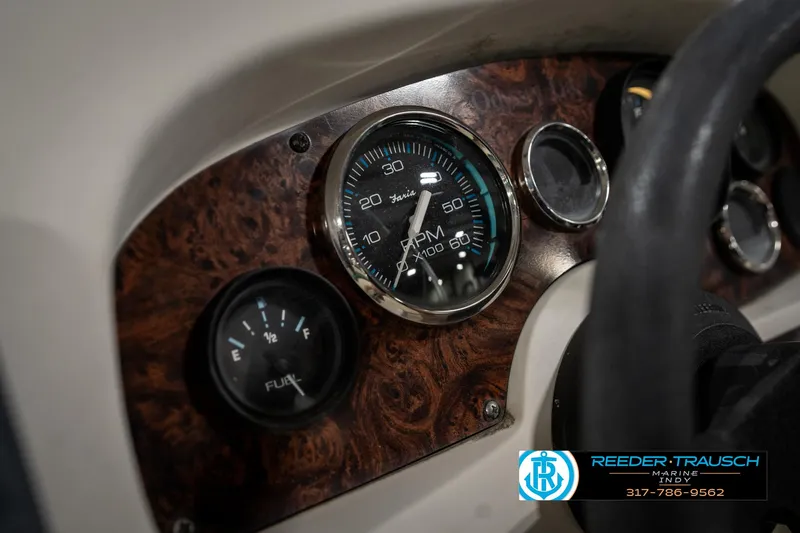 Slide: The Image of Dashboard of a 1998 Odyssey 25 boat with RPM and fuel gauges. - 33