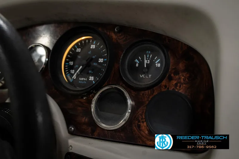 Slide: The Image of Dashboard of a 1998 Odyssey 25 with speedometer and voltmeter gauges. - 34