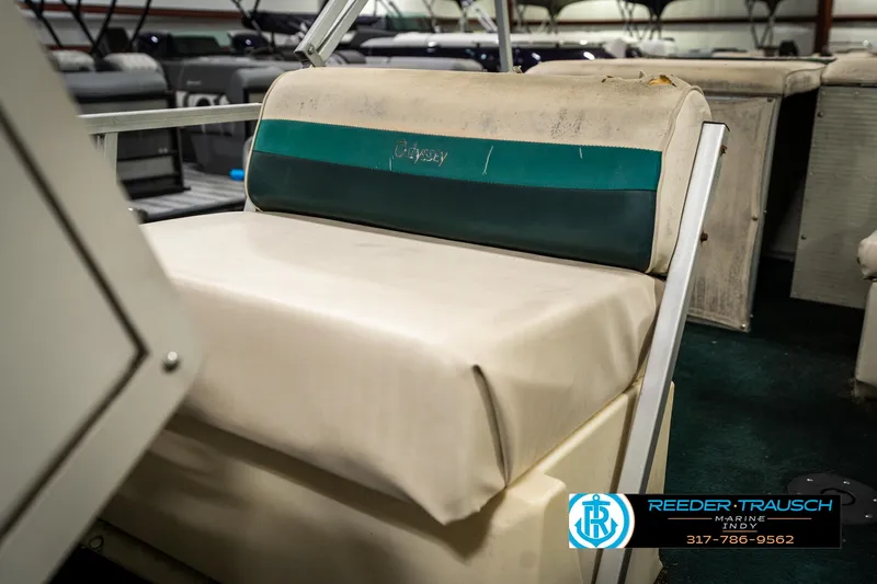 Slide: The Image of 1998 Odyssey 25 boat seat with green and white upholstery, displayed indoors. - 36