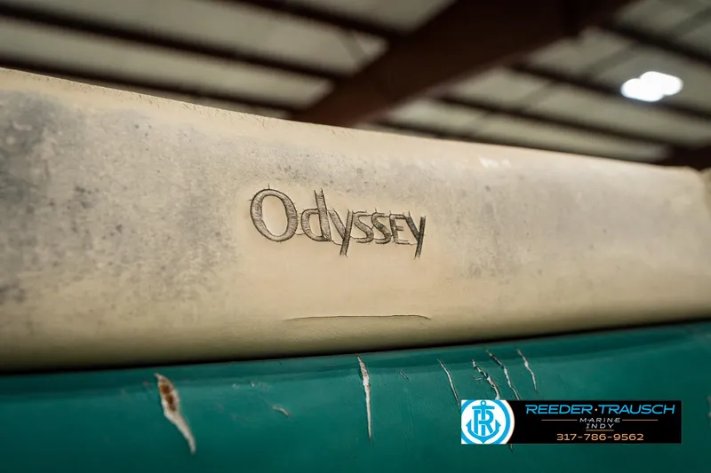 Slide: The Image of 1998 Odyssey 25 logo on a weathered surface in an indoor setting. - 37