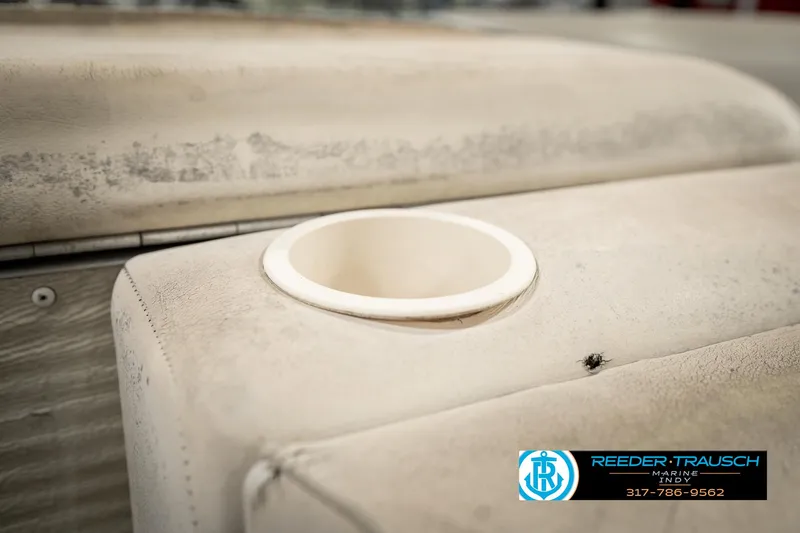 Slide: The Image of Worn seating with cup holder on a 1998 Odyssey 25 boat. - 38