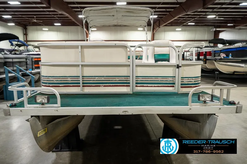 Slide: The Image of 1998 Odyssey 25 pontoon boat in indoor showroom, rear view. - 4