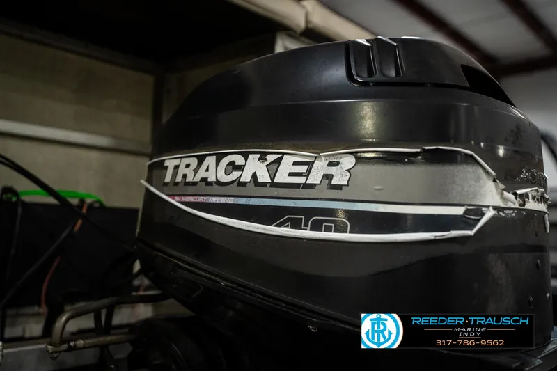 Slide: The Image of Tracker 40 outboard motor on a 1998 Odyssey 25 boat. - 40