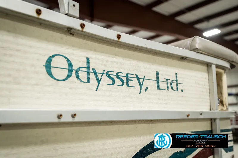 Slide: The Image of 1998 Odyssey 25 boat with "Odyssey, Ltd." branding in a warehouse setting. - 42