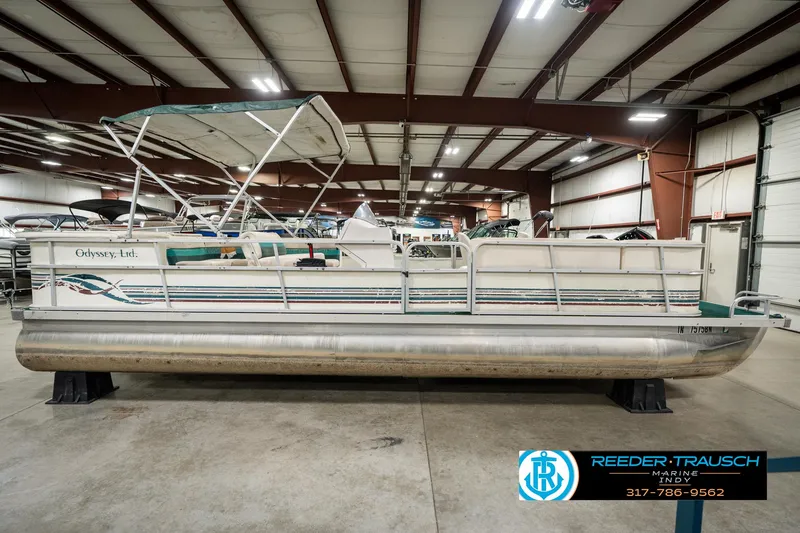 Slide: The Image of 1998 Odyssey 25 pontoon boat in indoor storage facility. - 6