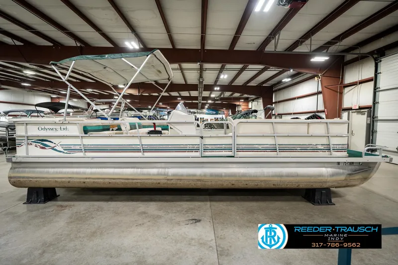 Slide: The Image of 1998 Odyssey 25 pontoon boat in indoor showroom, side view. - 7