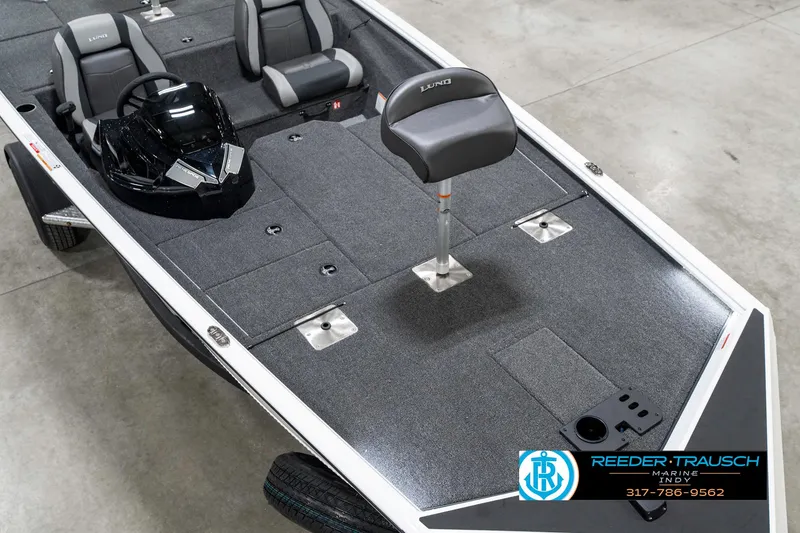 Slide: The Image of 2025 Lund 1775 Renegade fishing boat interior with seating and steering console. - 11