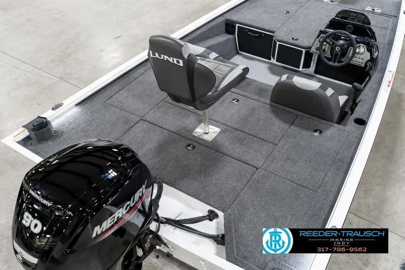 Slide: The Image of 2025 Lund 1775 Renegade boat interior with Mercury engine, featuring spacious seating and steering console. - 12