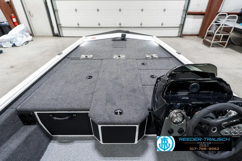 Slide: The Image of 2025 Lund 1775 Renegade boat interior with steering console and storage compartments. - 15