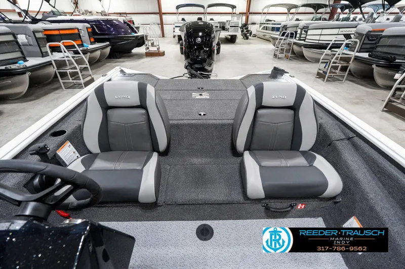 Slide: The Image of 2025 Lund 1775 Renegade boat interior with dual seats in showroom. - 18