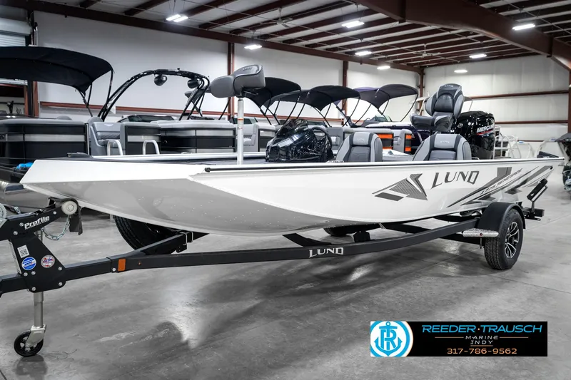 Slide: The Image of 2025 Lund 1775 Renegade boat on trailer in showroom, side view. - 2