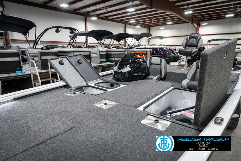 Slide: The Image of 2025 Lund 1775 Renegade boat interior with storage compartments in a showroom. - 22