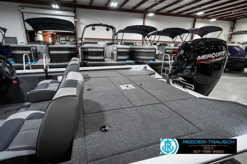 Slide: The Image of 2025 Lund 1775 Renegade boat interior with Mercury engine in showroom. - 26