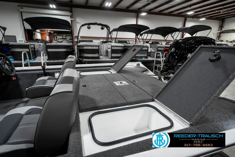 Slide: The Image of 2025 Lund 1775 Renegade boat interior with open storage compartments in showroom. - 27