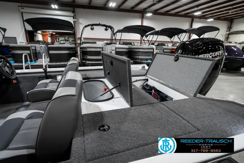 Slide: The Image of 2025 Lund 1775 Renegade boat interior with open storage compartments in showroom. - 28