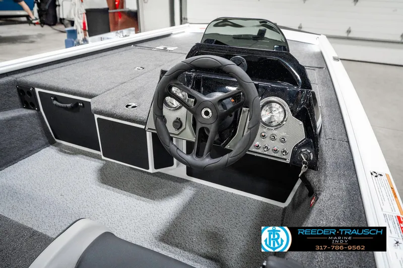 Slide: The Image of 2025 Lund 1775 Renegade boat interior with steering wheel and dashboard controls. - 29