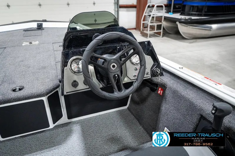 Slide: The Image of 2025 Lund 1775 Renegade boat interior with steering wheel and dashboard controls. - 30