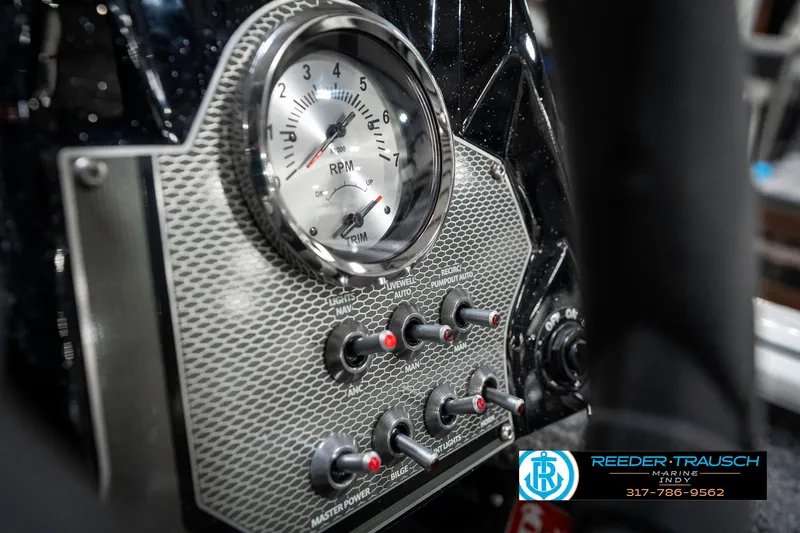 Slide: The Image of Control panel of 2025 Lund 1775 Renegade boat with RPM gauge and switches. - 33