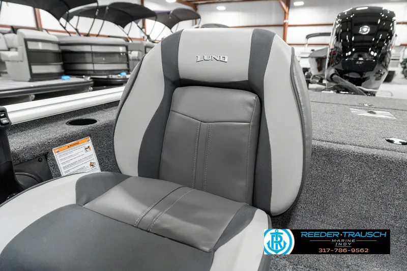 Slide: The Image of 2025 Lund 1775 Renegade boat seat in showroom, featuring gray and black upholstery. - 36