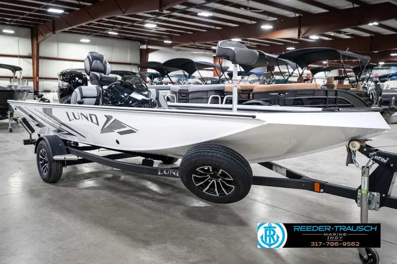 Slide: The Image of 2025 Lund 1775 Renegade boat on trailer in showroom, side view. - 4