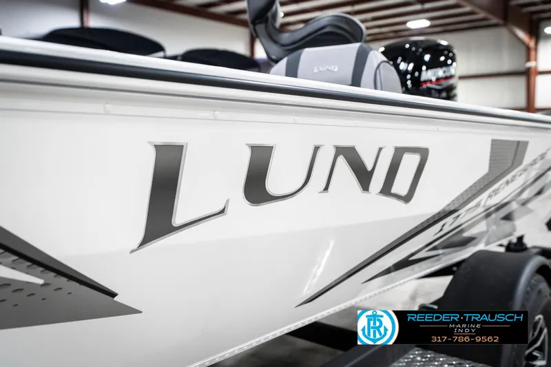 Slide: The Image of 2025 Lund 1775 Renegade boat in showroom, featuring sleek design and branding. - 45
