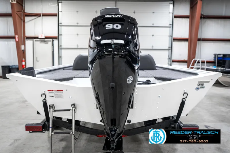 Slide: The Image of 2025 Lund 1775 Renegade boat with Mercury 90 engine in a warehouse setting. - 7