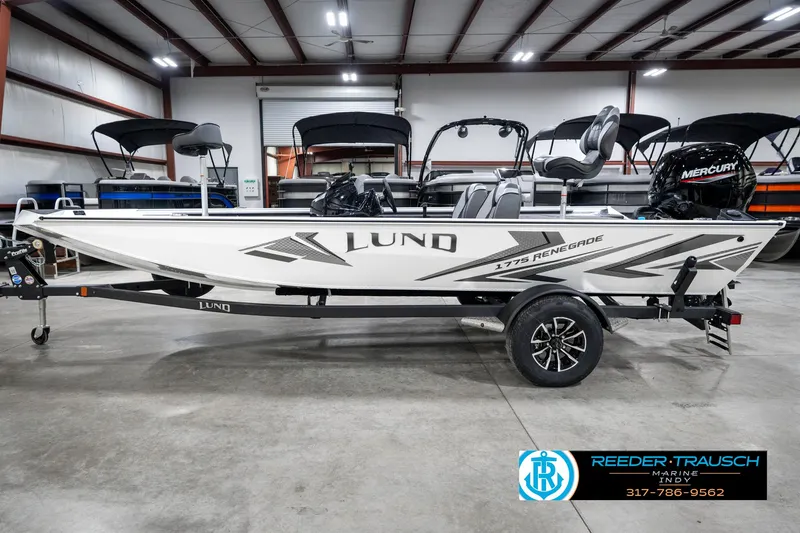 Slide: The Image of 2025 Lund 1775 Renegade boat in showroom, side view with trailer and Mercury engine. - 9