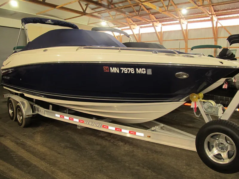 Slide: The Image of 2012 Monterey 264FS boat on trailer in indoor storage facility. - 0
