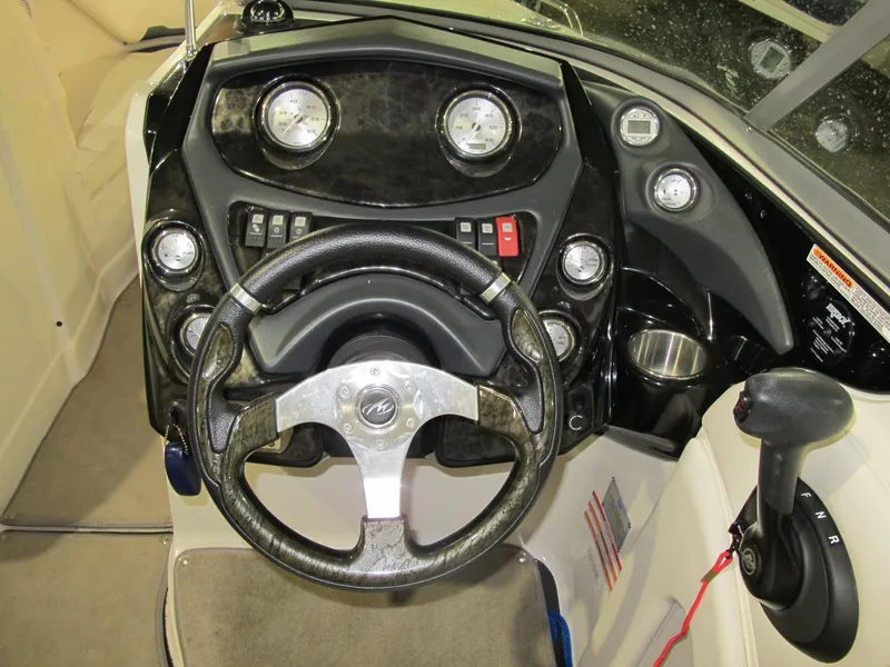 Slide: The Image of 2012 Monterey 264FS boat dashboard with steering wheel and control panel. - 11