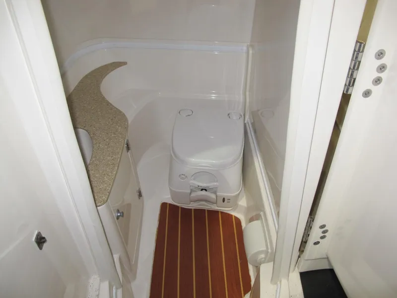 Slide: The Image of 2012 Monterey 264FS boat bathroom with compact toilet and countertop. - 12