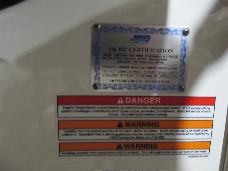 Slide: The Image of 2012 Monterey 264FS yacht certification and safety warning labels. - 15