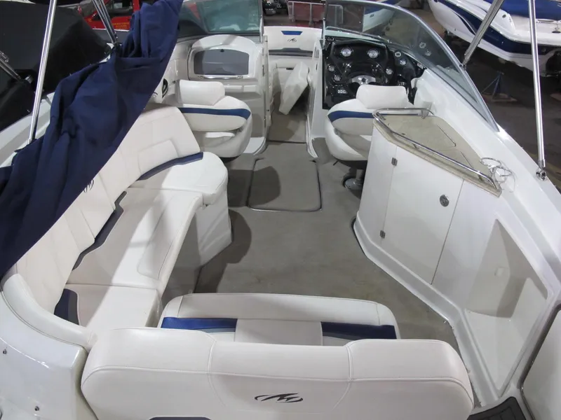 Slide: The Image of 2012 Monterey 264FS boat interior with white seating and dashboard. - 5