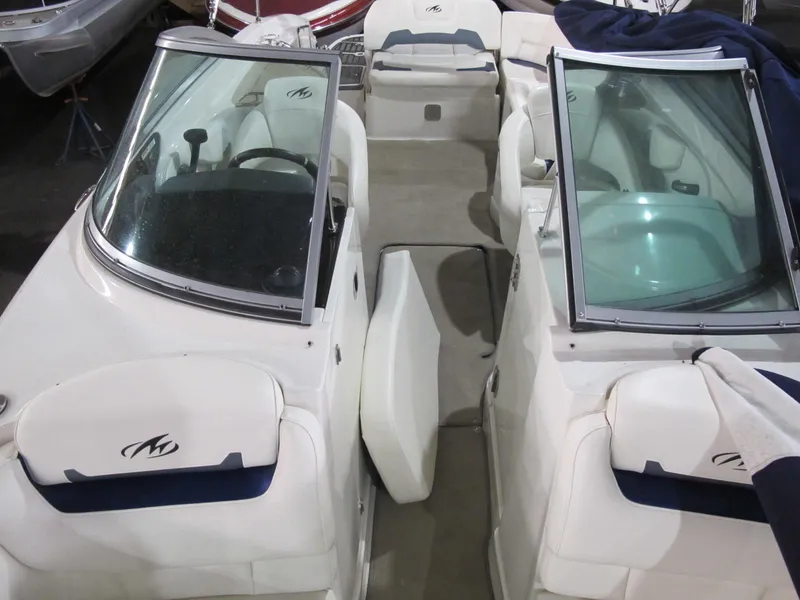 Slide: The Image of 2012 Monterey 264FS boat interior with dual windshields and seating, showcasing sleek design. - 6