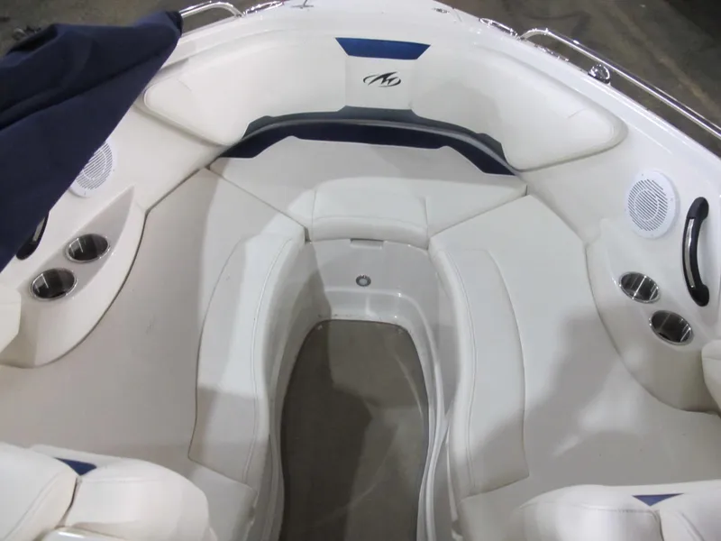 Slide: The Image of Interior of a 2012 Monterey 264FS boat with white seating and cup holders. - 7