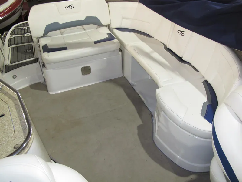 Slide: The Image of 2012 Monterey 264FS boat interior with white seating and blue accents. - 8