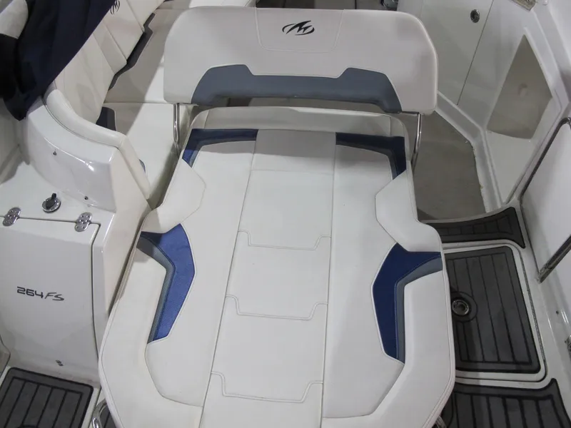 Slide: The Image of 2012 Monterey 264FS boat interior with white and blue seating. - 9