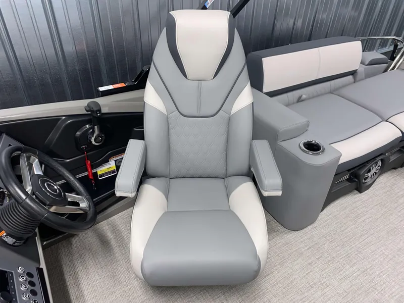 Slide: The Image of 2025 Avalon Catalina 2385 QLS Tritoon interior with gray captain's chair and seating. - 10