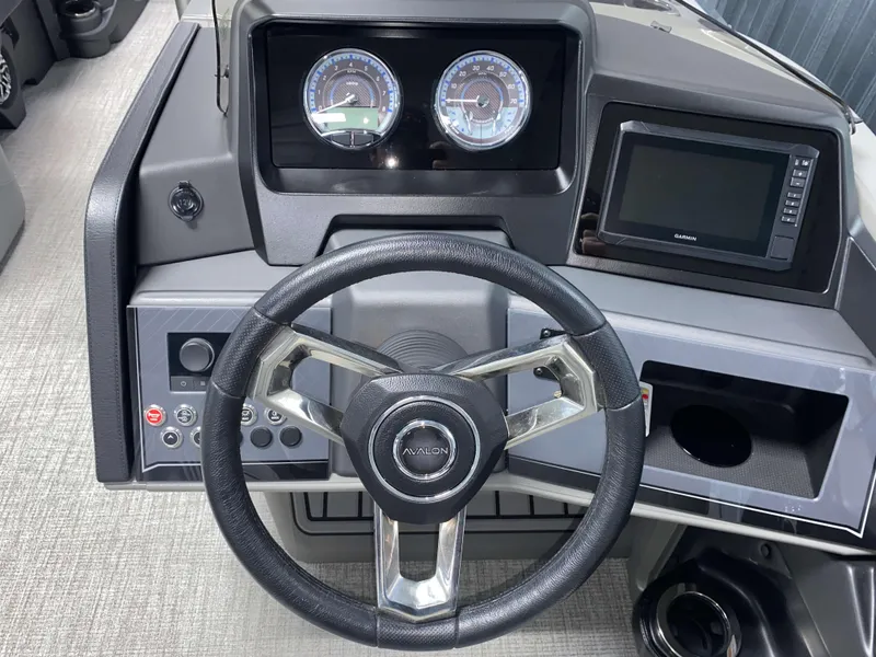 Slide: The Image of Steering console of 2025 Avalon Catalina 2385 QLS Tritoon with gauges and navigation display. - 11