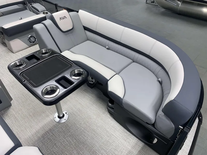 Slide: The Image of 2025 Avalon Catalina 2385 QLS Tritoon interior with plush seating and cupholders. - 14