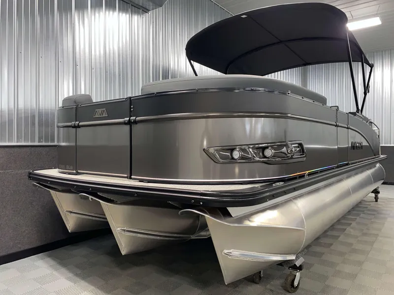 Slide: The Image of 2025 Avalon Catalina 2385 QLS Tritoon in a showroom, featuring sleek design and modern amenities. - 17