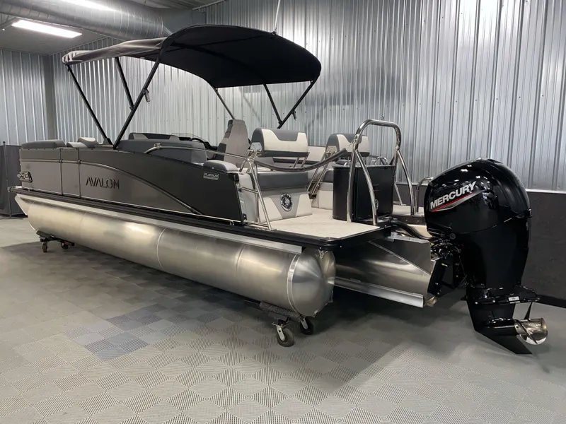 Slide: The Image of 2025 Avalon Catalina 2385 QLS Tritoon with Mercury engine in a showroom. - 21