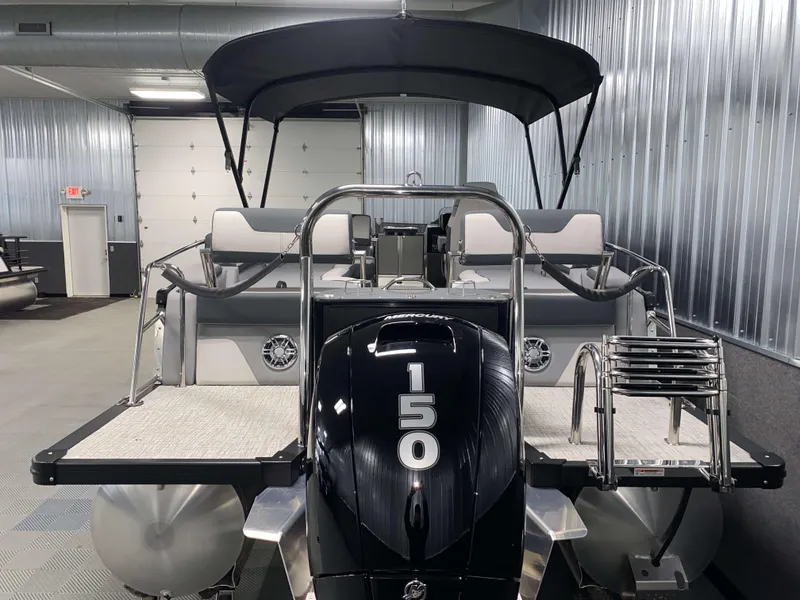 Slide: The Image of 2025 Avalon Catalina 2385 QLS Tritoon with 150 HP engine in a showroom. - 22